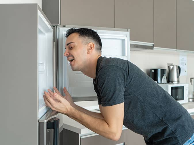 man cooling off in freezer